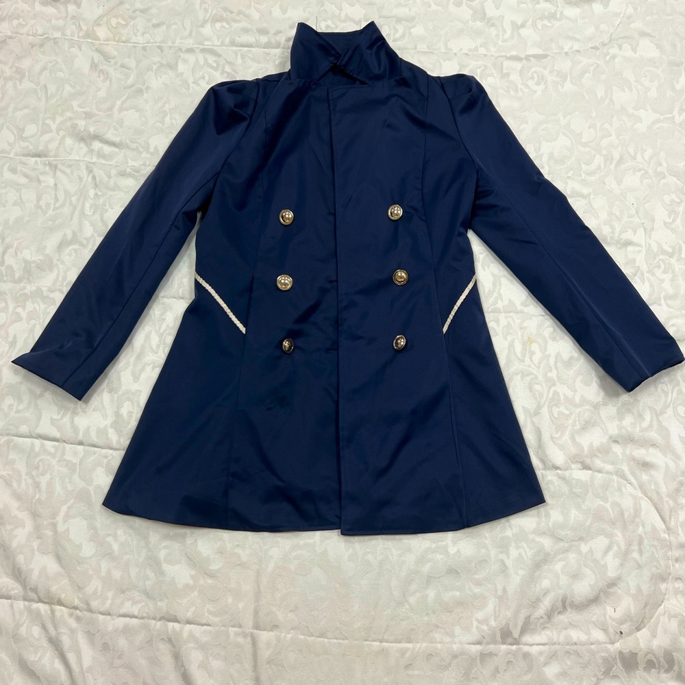 This fashionable coat is from a store in the Middle East one of a navy blue.
